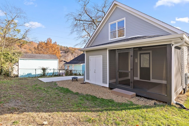 rear view of property featuring a yard