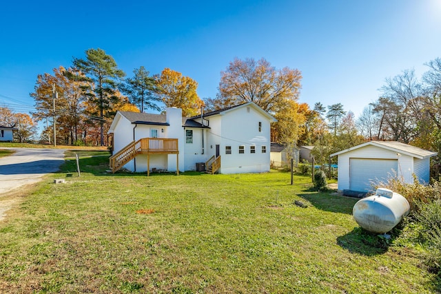 view of side of property with a lawn, an outbuilding, central AC unit, and a garage