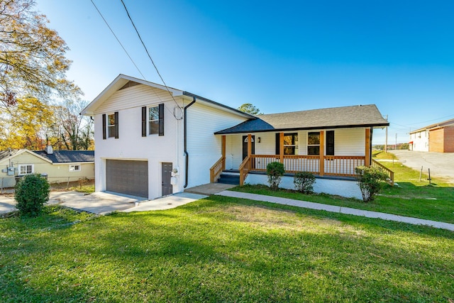 tri-level home featuring covered porch, a garage, and a front lawn