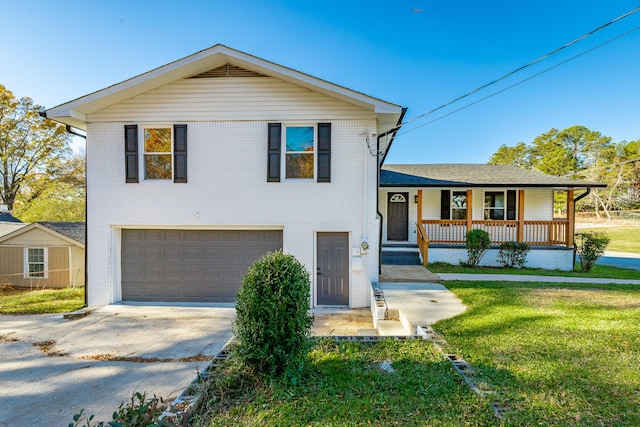 tri-level home with a front yard, a porch, and a garage