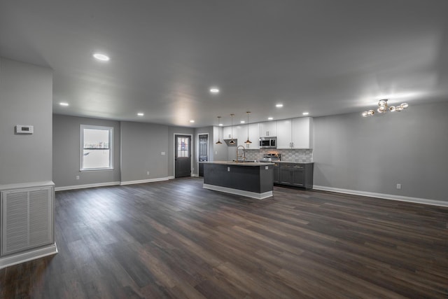 unfurnished living room with sink and dark hardwood / wood-style floors