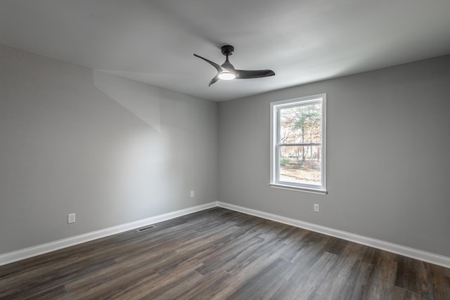 empty room featuring ceiling fan and dark hardwood / wood-style flooring