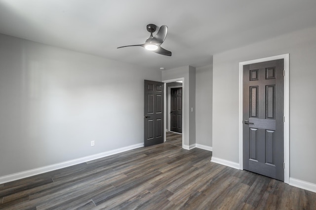 unfurnished bedroom with ceiling fan and dark hardwood / wood-style floors