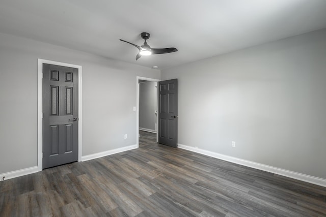 unfurnished bedroom featuring ceiling fan and dark wood-type flooring