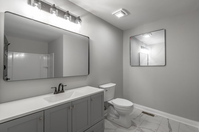 bathroom featuring walk in shower, vanity, and toilet