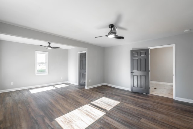 unfurnished room with dark hardwood / wood-style flooring and ceiling fan