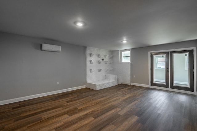 interior space featuring a wall mounted air conditioner and dark wood-type flooring