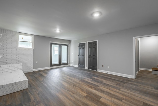 unfurnished living room with dark hardwood / wood-style floors