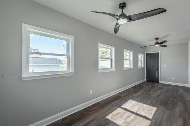 unfurnished room featuring ceiling fan and dark wood-type flooring