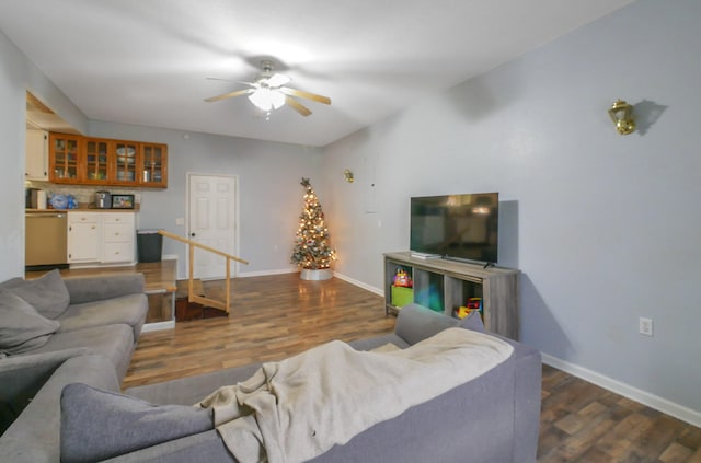 living room with ceiling fan and dark hardwood / wood-style flooring