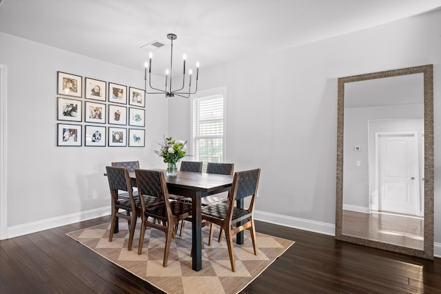 dining area featuring dark wood-style floors, baseboards, and a chandelier