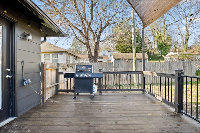 deck featuring area for grilling and fence