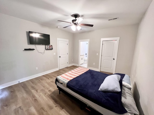 bedroom featuring hardwood / wood-style floors, ensuite bath, and ceiling fan