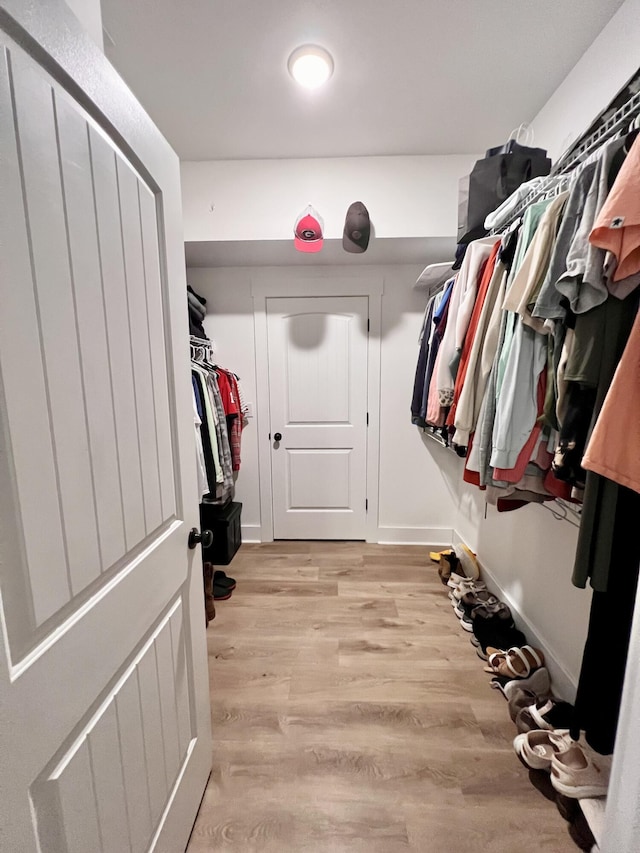 spacious closet featuring light hardwood / wood-style floors