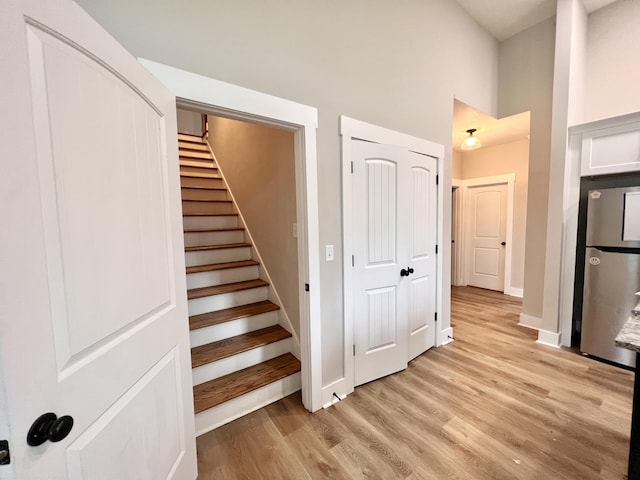 stairway with hardwood / wood-style floors