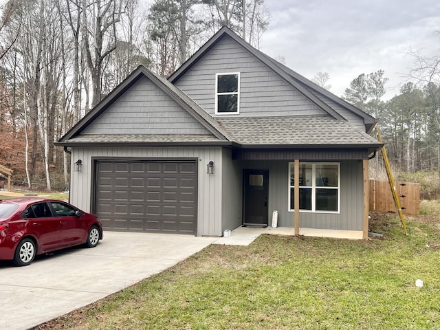 view of front of house with a front yard and a garage