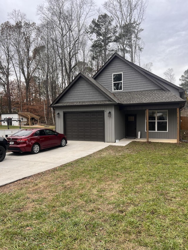 view of front of home featuring a garage and a front lawn