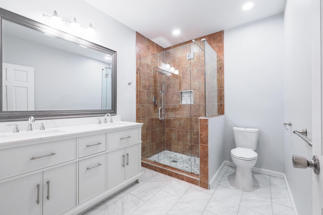 bathroom featuring vanity, a shower with shower door, and toilet