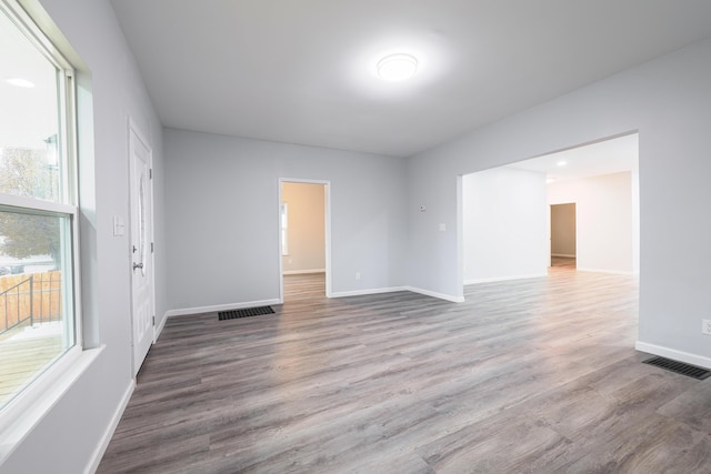 unfurnished room with wood-type flooring