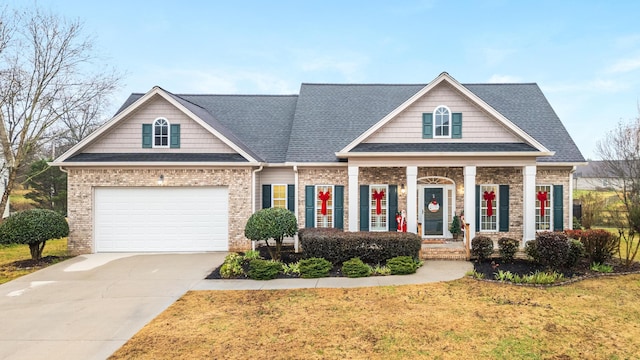 craftsman inspired home featuring a garage and a front yard