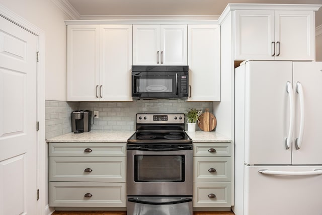 kitchen with stainless steel electric stove, white fridge, and white cabinets