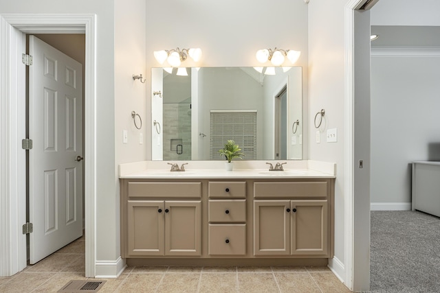 bathroom featuring tile patterned floors, crown molding, vanity, and a shower with shower door