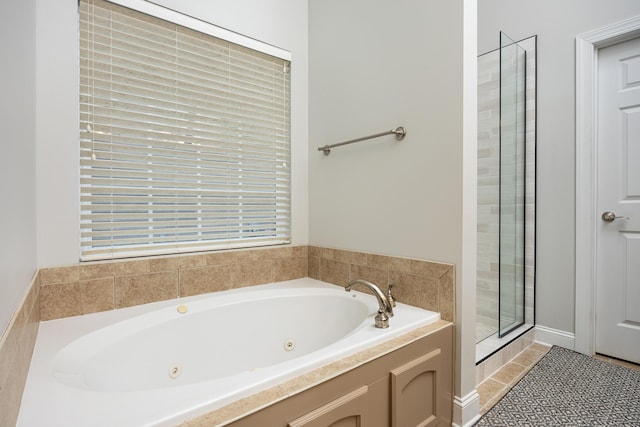 bathroom featuring tile patterned floors and separate shower and tub