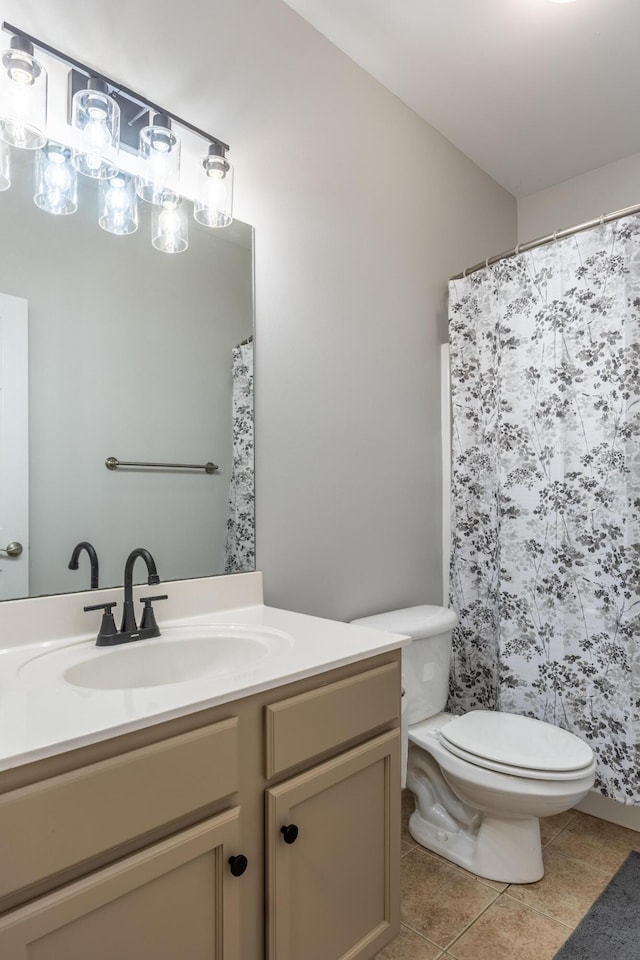 bathroom featuring tile patterned floors, vanity, and toilet