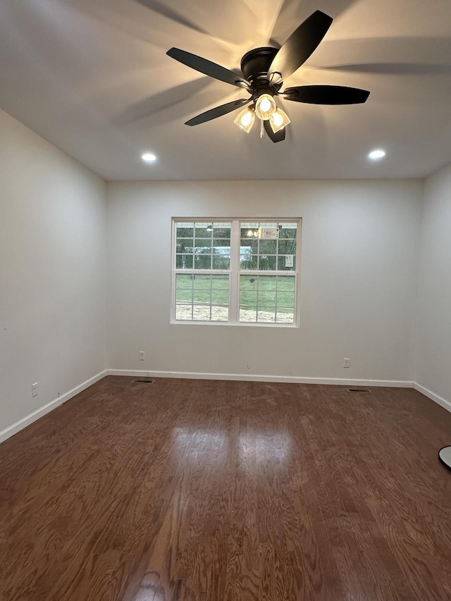 empty room featuring ceiling fan and dark hardwood / wood-style floors