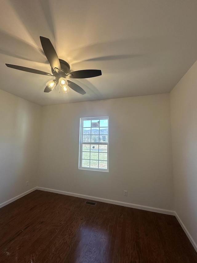 empty room featuring ceiling fan and dark hardwood / wood-style flooring