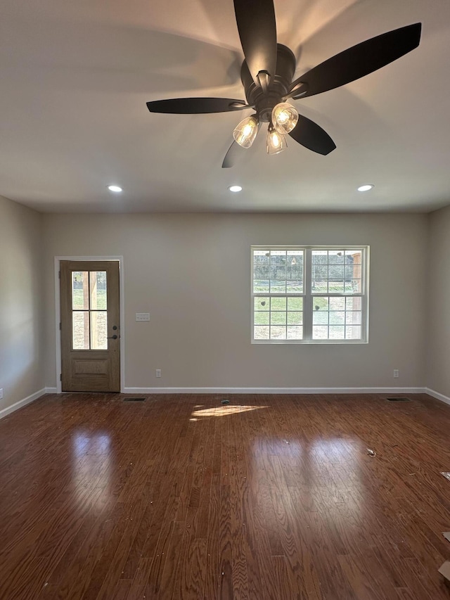 unfurnished room with ceiling fan and dark hardwood / wood-style flooring