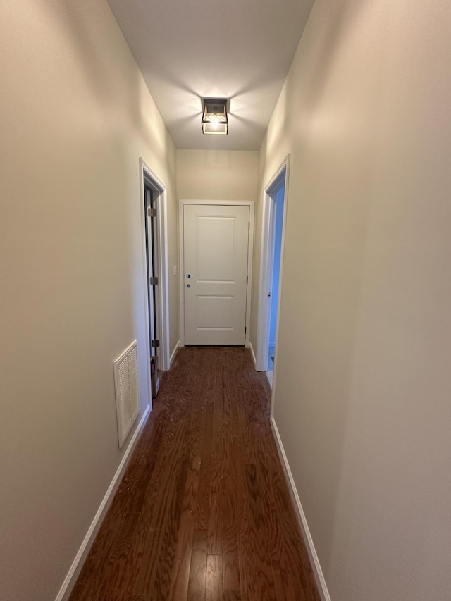 corridor featuring dark hardwood / wood-style floors