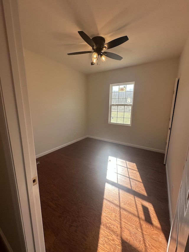 unfurnished room with ceiling fan and dark hardwood / wood-style floors