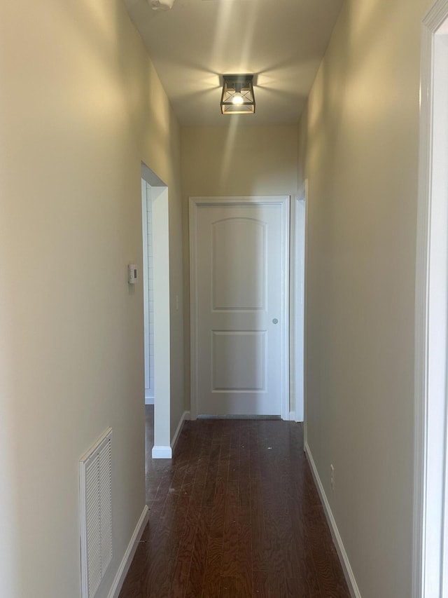 corridor with dark wood-type flooring