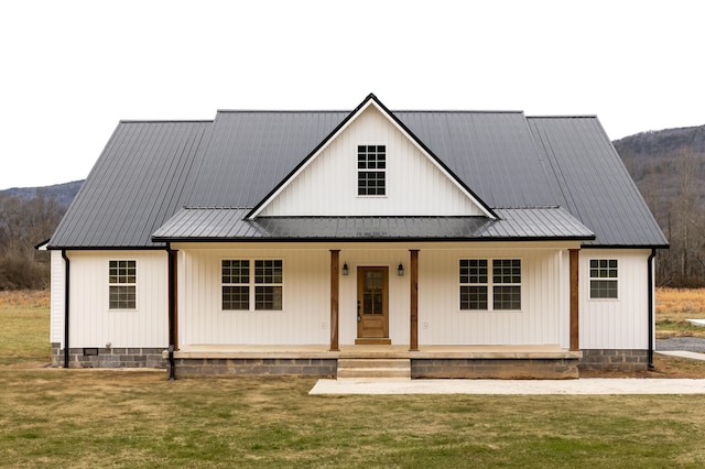 modern farmhouse with a front yard and a porch