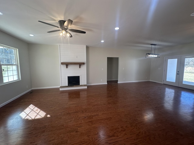 unfurnished living room with recessed lighting, a large fireplace, a ceiling fan, baseboards, and dark wood finished floors