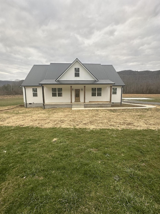 modern farmhouse style home featuring metal roof, a front lawn, crawl space, and a porch