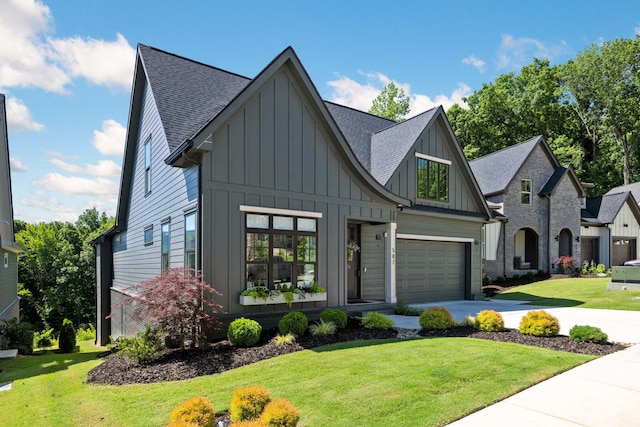 view of front of property with a front yard and a garage