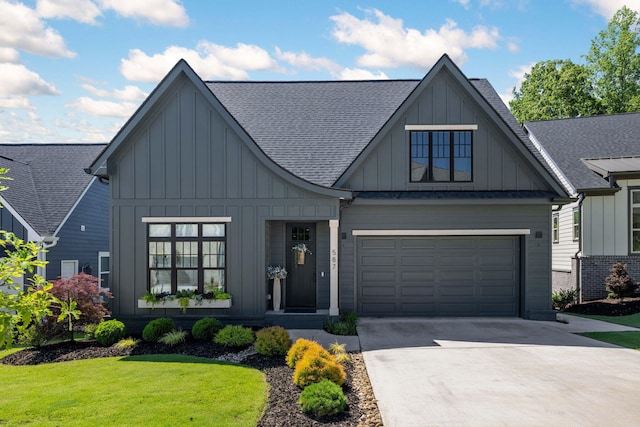 view of front of home with a garage and a front yard