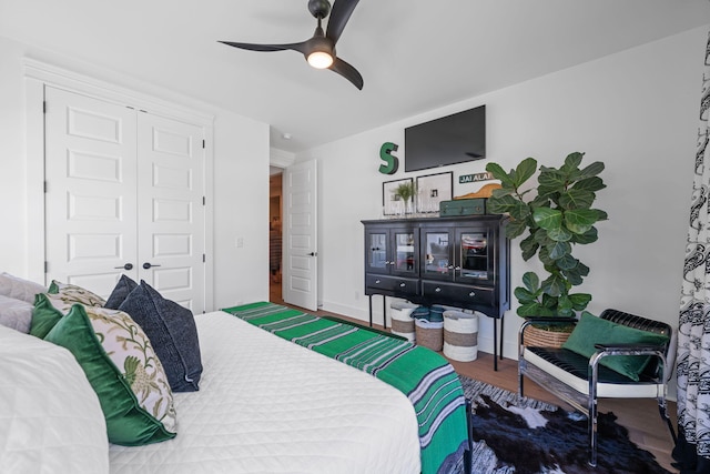 bedroom featuring wood-type flooring, a closet, and ceiling fan