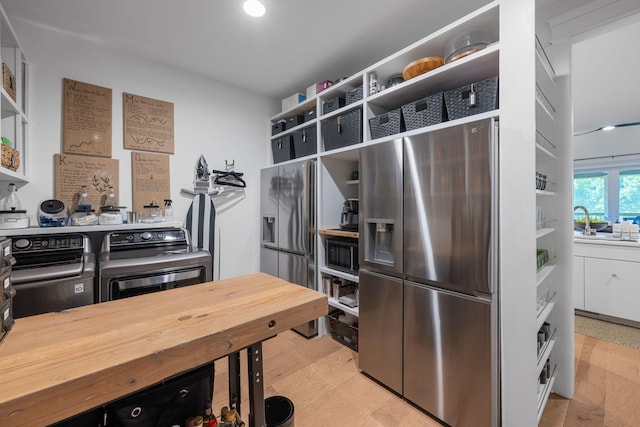 kitchen with stainless steel refrigerator with ice dispenser, light wood-type flooring, black microwave, and butcher block counters