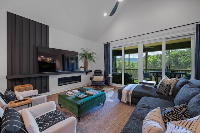 living room featuring hardwood / wood-style floors, ceiling fan, and high vaulted ceiling