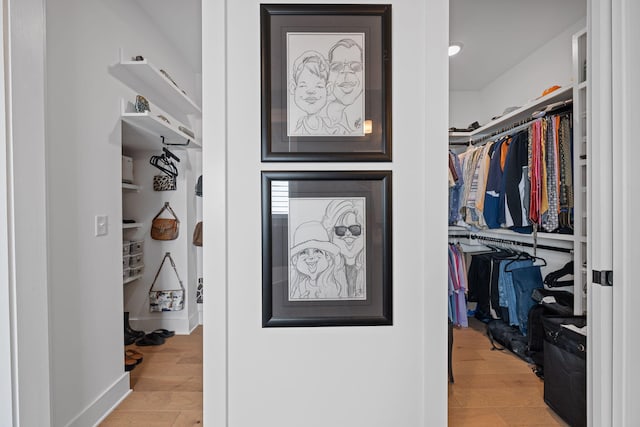 spacious closet featuring light hardwood / wood-style floors