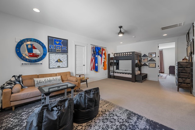 carpeted living room with ceiling fan