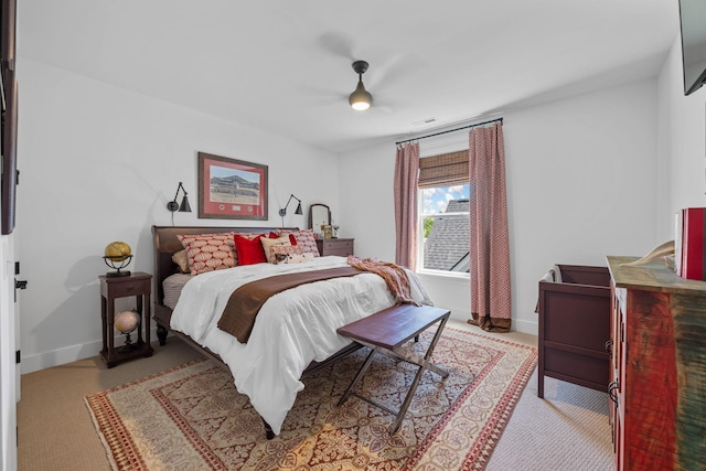 bedroom with ceiling fan and light carpet