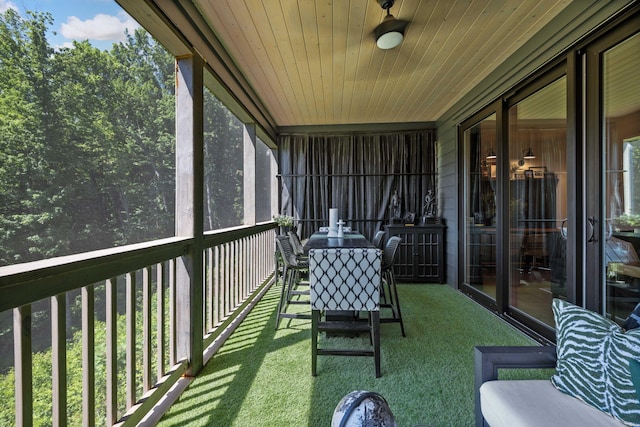 unfurnished sunroom featuring wood ceiling