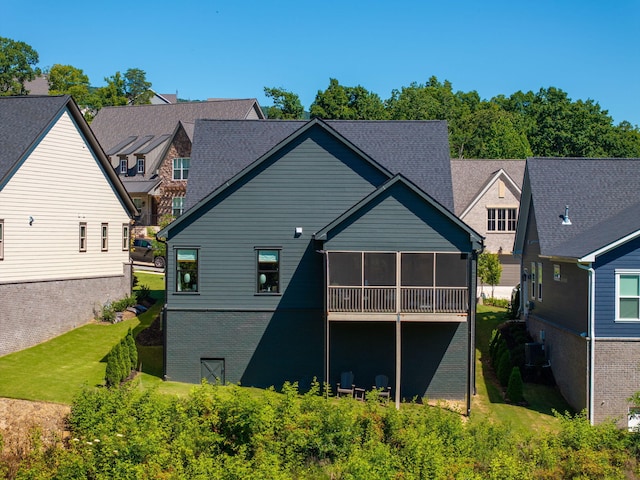 back of house with a lawn and central air condition unit