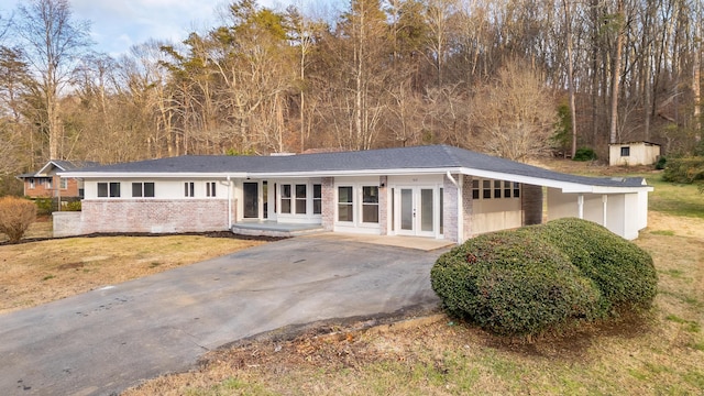 view of front of house featuring a carport and french doors