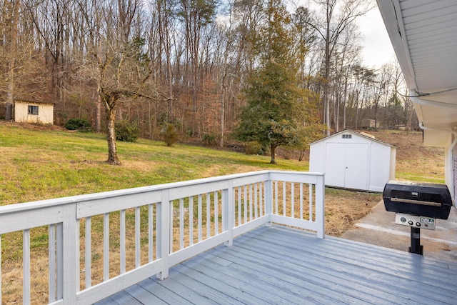 wooden terrace featuring a yard and a shed