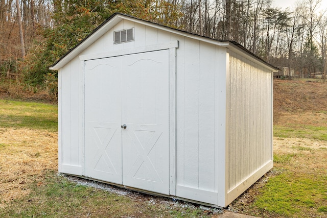 view of outbuilding featuring a lawn